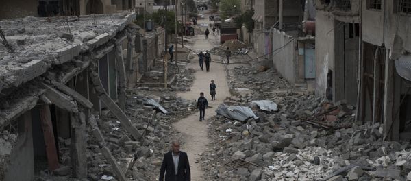 Iraqi civilians walk in a neighborhood recently liberated by Iraqi security forces on the western side of Mosul, Iraq - Sputnik International