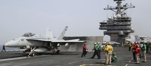 In this Wednesday, March 22, 2017 photograph, sailors prepare to launch an F-18 off of the USS George H.W. Bush as it travels through the Persian Gulf. - Sputnik International
