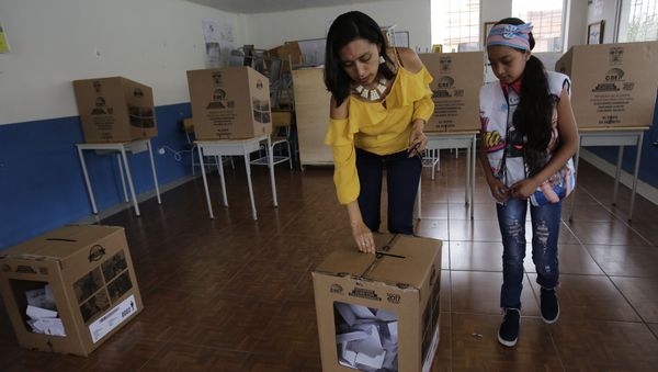 A woman deposits her ballot during the presidential runoff election Quito, Ecuador, Sunday, April 2, 2017 A woman deposits her ballot during the presidential runoff election Quito, Ecuador, Sunday, April 2, 2017 - Sputnik International