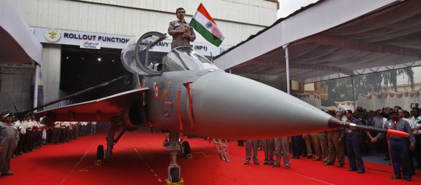 A Hindustan Aeronautics Limited engineer hurls the Indian flag as he stands in the cockpit of India's first indigenous naval Light Combat Aircraft LCA (Navy) NP1 during its roll out ceremony in Bangalore, India, Tuesday, July 6, 2010 A Hindustan Aeronautics Limited engineer hurls the Indian flag as he stands in the cockpit of India's first indigenous naval Light Combat Aircraft LCA (Navy) NP1 during its roll out ceremony in Bangalore, India, Tuesday, July 6, 2010 - Sputnik International