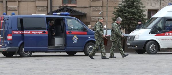Members of the security services walk past a vehicle of Russia's Investigative Committee outside Sennaya Ploshchad metro station after an explosion tore through a train carriage in the St. Petersburg metro system, in St. Petersburg, Russia April 3, 2017 Members of the security services walk past a vehicle of Russia's Investigative Committee outside Sennaya Ploshchad metro station after an explosion tore through a train carriage in the St. Petersburg metro system, in St. Petersburg, Russia April 3, 2017 - Sputnik International