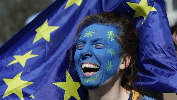 A demonstrator with her face painted in the colours of the EU flag A demonstrator with her face painted in the colours of the EU flag - Sputnik International