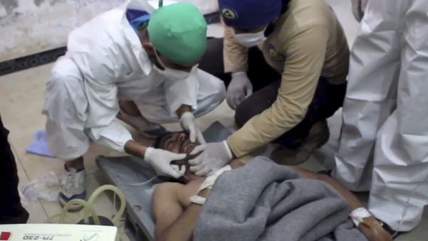 A victim of a suspected chemical attack as he receives treatment at a makeshift hospital, in the town of Khan Sheikhoun, northern Idlib province, Syria. File photo - Sputnik International