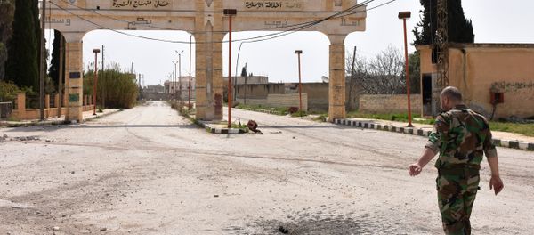 A member of the Syrian government forces walks in Deir Hafer on the eastern outskirts of Aleppo on March 30, 2017, after they took control of the town from Islamic State (IS) group fighters. A member of the Syrian government forces walks in Deir Hafer on the eastern outskirts of Aleppo on March 30, 2017, after they took control of the town from Islamic State (IS) group fighters. - Sputnik International