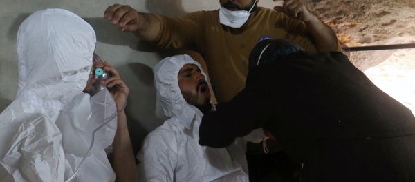 A man breathes through an oxygen mask as another one receives treatments, after what rescue workers described as a suspected gas attack in the town of Khan Sheikhoun in rebel-held Idlib, Syria A man breathes through an oxygen mask as another one receives treatments, after what rescue workers described as a suspected gas attack in the town of Khan Sheikhoun in rebel-held Idlib, Syria - Sputnik International