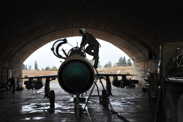 A Syrian pilot checks a MiG-21 aircraft of the Syrian Air Force before a mission at the Hama airbase near the city of Hama, Syria's Hama Province. (File) - Sputnik International