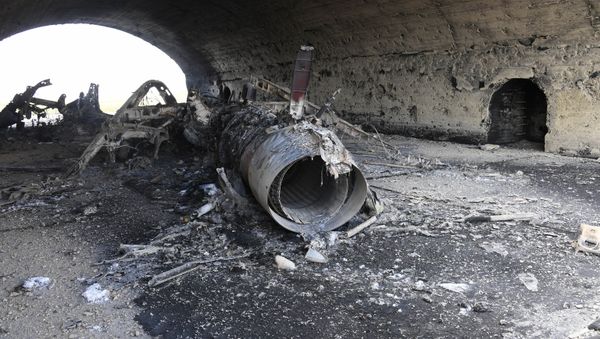 The body of a plane burned as a result of the US missile strike on an air base in Syria - Sputnik International