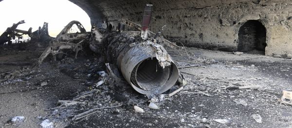 The body of a plane burned as a result of the US missile strike on an air base in Syria The body of a plane burned as a result of the US missile strike on an air base in Syria - Sputnik International