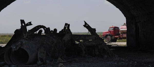 The body of a plane burned as a result of the US missile attack on an air base in Syria The body of a plane burned as a result of the US missile attack on an air base in Syria - Sputnik International