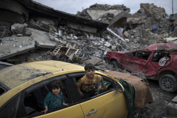 Children play inside a damaged car, amid heavy destruction in a neighborhood recently retaken by Iraqi security forces from Islamic State militants on the western side of Mosul, Iraq, Saturday, April 1, 2017 Children play inside a damaged car, amid heavy destruction in a neighborhood recently retaken by Iraqi security forces from Islamic State militants on the western side of Mosul, Iraq, Saturday, April 1, 2017 - Sputnik International