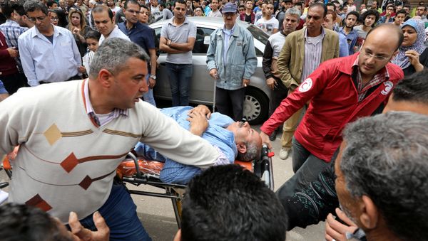 A victim is seen on a stretcher after a bomb went off at a Coptic church in Tanta, Egypt, April 9, 2017 - Sputnik International