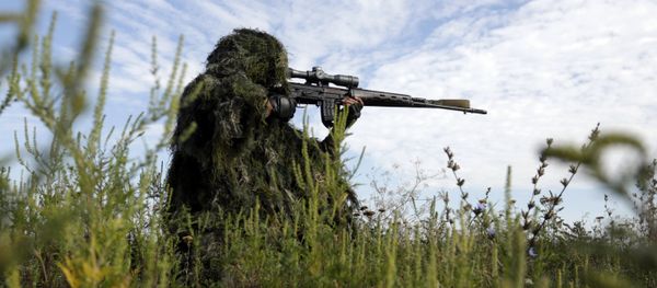 A Ukrainian sniper holds on the position of Ukrainian forces on frontline in the Lugansk region on August 27, 2015 A Ukrainian sniper holds on the position of Ukrainian forces on frontline in the Lugansk region on August 27, 2015 - Sputnik International