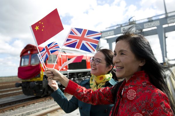 People wave a Chinese and a Union flags as they pose for photographs during a photcall to witness the departure of a freight train transporting containers laden with goods from the UK, from DP World London Gateway's rail freight depot in Corringham, east of London, on April 10, 2017, enroute to Yiwu in the eastern Chinese province of Zhejiang. People wave a Chinese and a Union flags as they pose for photographs during a photcall to witness the departure of a freight train transporting containers laden with goods from the UK, from DP World London Gateway's rail freight depot in Corringham, east of London, on April 10, 2017, enroute to Yiwu in the eastern Chinese province of Zhejiang. - Sputnik International