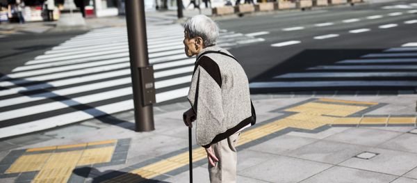 A Japanese elderly woman waits for the traffic light to cross the street in Nagano, northwest of the capital Tokyo on November 7, 2016 - Sputnik International