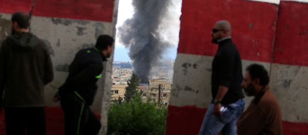 People stand behind a Lebanese Army barrier as smoke rises during clashes between Islamists and Palestinian Fatah gunmen in Ain al-Hilweh camp Palestinian refugee camp near Sidon, South Lebanon April 9, 2017 - Sputnik International