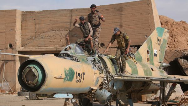 Syrian Democratic Forces (SDF) fighters gesture while posing on a damaged airplane inside Tabqa military airport after taking control of it from Islamic State fighters, west of Raqqa city, Syria April 9, 2017 Syrian Democratic Forces (SDF) fighters gesture while posing on a damaged airplane inside Tabqa military airport after taking control of it from Islamic State fighters, west of Raqqa city, Syria April 9, 2017 - Sputnik International