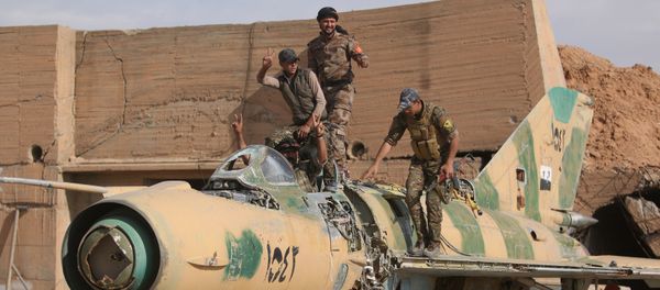 Syrian Democratic Forces (SDF) fighters gesture while posing on a damaged airplane inside Tabqa military airport after taking control of it from Islamic State fighters, west of Raqqa city, Syria April 9, 2017 Syrian Democratic Forces (SDF) fighters gesture while posing on a damaged airplane inside Tabqa military airport after taking control of it from Islamic State fighters, west of Raqqa city, Syria April 9, 2017 - Sputnik International