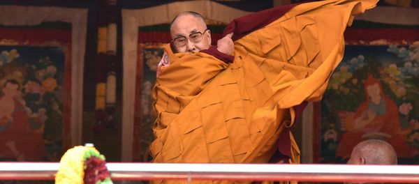 Exiled Tibetan spiritual leader the Dalai Lama adjusts his shawl as he came to deliver his religious teaching at Yiga Choezin ground at in Tawang District near India-china border in India's north-eastern state of Arunachal Pradesh state, on April 8, 2017 - Sputnik International