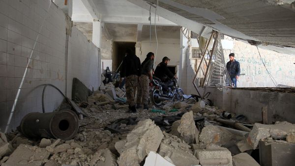 Men salvage a motorbike amid the damage inside a medical point at a site hit by airstrikes on Tuesday, in the town of Khan Sheikhoun in rebel-held Idlib, Syria April 5, 2017 - Sputnik International