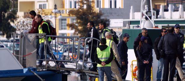 Frontex officials and Greek police escort migrants aboard a Turkish boat heading to Turkey from the port of Mytilene on the Greek island of Lesbos on October 21, 2016 Frontex officials and Greek police escort migrants aboard a Turkish boat heading to Turkey from the port of Mytilene on the Greek island of Lesbos on October 21, 2016 - Sputnik International