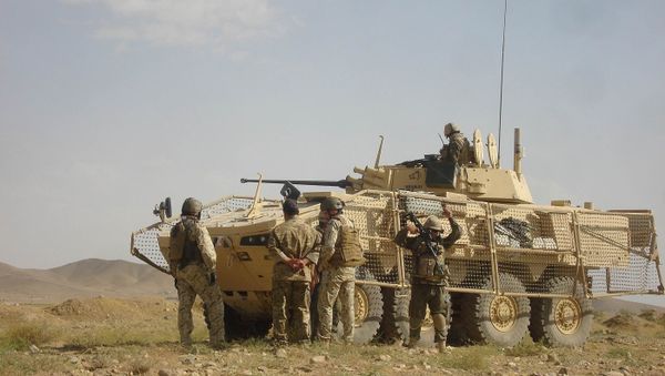 In this photograph taken on December 21, 2011, Polish soldiers with the NATO-led International Security Assistance Force (ISAF) stand guard after five of their comrades were killed when their armored military vehicle was hit by a roadside bomb in Ghazni province - Sputnik International