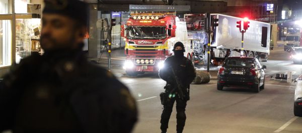 Police officers guard the scene as a truck is pulled away by a service car after it was driven into a department store in Stockholm, Sweden, Saturday, April 8, 2017 Police officers guard the scene as a truck is pulled away by a service car after it was driven into a department store in Stockholm, Sweden, Saturday, April 8, 2017 - Sputnik International
