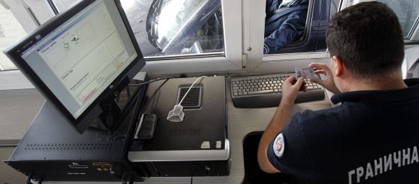 In this Oct. 22, 2012 photo a Serbian border police officer checks the identification of passengers as the car is crossing from Macedonia to the Serbia, at the Presevo border crossing, 380 kms south of Belgrade, Serbia. In this Oct. 22, 2012 photo a Serbian border police officer checks the identification of passengers as the car is crossing from Macedonia to the Serbia, at the Presevo border crossing, 380 kms south of Belgrade, Serbia. - Sputnik International