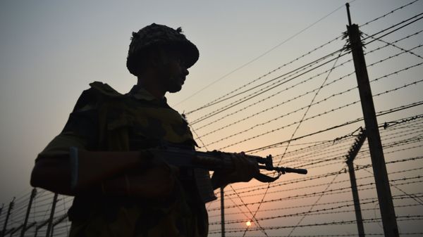 An Indian Border Security Force (BSF) soldier patrols along a fence at the India-Pakistan border in R.S Pora, southwest of Jammu, on October 3, 2016 - Sputnik International