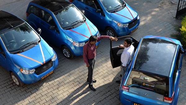 An employee of Indian company Carzonrent interacts with a prospective customer ahead of hiring a Mahindra Reva electric car in Bangalore An employee of Indian company Carzonrent interacts with a prospective customer ahead of hiring a Mahindra Reva electric car in Bangalore - Sputnik International