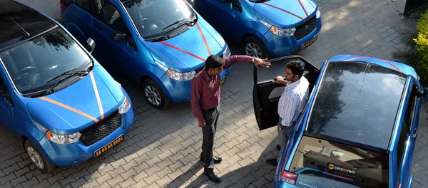 An employee of Indian company Carzonrent interacts with a prospective customer ahead of hiring a Mahindra Reva electric car in Bangalore An employee of Indian company Carzonrent interacts with a prospective customer ahead of hiring a Mahindra Reva electric car in Bangalore - Sputnik International