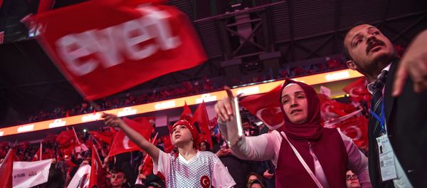 Supporters wave Turkey's national flags and a flag reading Yes in Turkish (L) during a campaign rally of Turkey's president on April 12, 2017 during a 15 July Martyrs meeting and a campaign rally for the yes vote in a constitutional referendum in Istanbul Supporters wave Turkey's national flags and a flag reading Yes in Turkish (L) during a campaign rally of Turkey's president on April 12, 2017 during a 15 July Martyrs meeting and a campaign rally for the yes vote in a constitutional referendum in Istanbul - Sputnik International