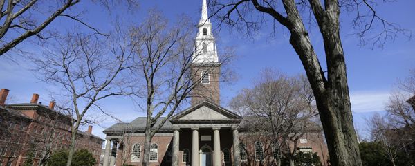 In this Sunday, March 13, 2016, photo people walk near Memorial Church, behind, on the campus of Harvard University, in Cambridge, Mass. Amid scrutiny from Congress and campus activists, colleges across the country are under growing pressure to reveal the financial investments made using their endowments. In this Sunday, March 13, 2016, photo people walk near Memorial Church, behind, on the campus of Harvard University, in Cambridge, Mass. Amid scrutiny from Congress and campus activists, colleges across the country are under growing pressure to reveal the financial investments made using their endowments. - Sputnik International