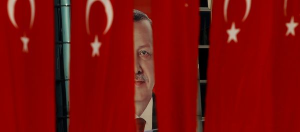 A picture of Turkish President Tayyip Erdogan is seen through Turkish national flags ahead of the constitutional referendum in Istanbul, Turkey, April 14, 2017. A picture of Turkish President Tayyip Erdogan is seen through Turkish national flags ahead of the constitutional referendum in Istanbul, Turkey, April 14, 2017. - Sputnik International