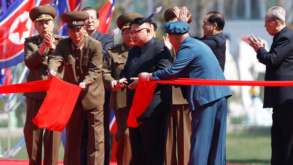 North Korean leader Kim Jong Un cuts the ribbon during an opening ceremony of a newly constructed residential complex in Ryomyong street in Pyongyang, North Korea April 13, 2017. - Sputnik International