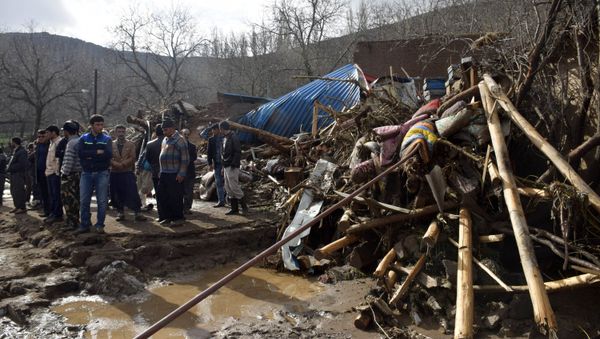 In this picture released by Islamic Republic News Agency, IRNA, villagers stand next to wreckages of buildings in Chenar village near city of Ajabshir in northwestern Iran, Saturday, April 15, 2017. - Sputnik International