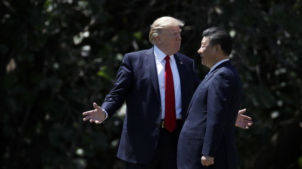 President Donald Trump gestures as he and Chinese President Xi Jinping walk together after their meetings at Mar-a-Lago in Palm Beach, Fla President Donald Trump gestures as he and Chinese President Xi Jinping walk together after their meetings at Mar-a-Lago in Palm Beach, Fla - Sputnik International