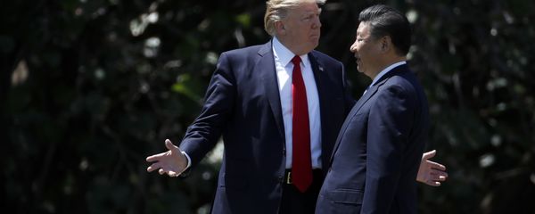 President Donald Trump gestures as he and Chinese President Xi Jinping walk together after their meetings at Mar-a-Lago in Palm Beach, Fla - Sputnik International
