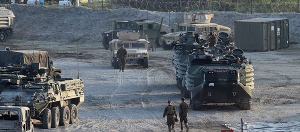 This file photo taken on April 14, 2016 shows US marines walking next to their transport and amphibious vehicles at a temporary camp for the Balikatan joint US-Philippine military exercise at Crow Valley, in Capas town, north of Manila This file photo taken on April 14, 2016 shows US marines walking next to their transport and amphibious vehicles at a temporary camp for the Balikatan joint US-Philippine military exercise at Crow Valley, in Capas town, north of Manila - Sputnik International
