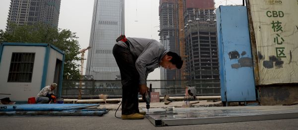 In this Sunday, April 16, 2017 photo, a worker assembles an aluminum platform outside a construction site at the Central Business District of Beijing In this Sunday, April 16, 2017 photo, a worker assembles an aluminum platform outside a construction site at the Central Business District of Beijing - Sputnik International