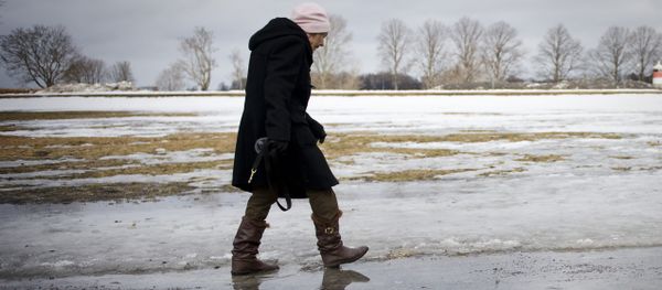 An elderly woman walks on melted snow in Djurgaarden area in Stockholm on March 21, 2011 An elderly woman walks on melted snow in Djurgaarden area in Stockholm on March 21, 2011 - Sputnik International