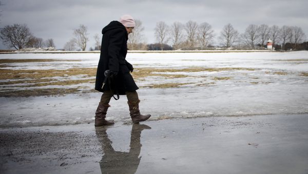 An elderly woman walks on melted snow in Djurgaarden area in Stockholm on March 21, 2011 An elderly woman walks on melted snow in Djurgaarden area in Stockholm on March 21, 2011 - Sputnik International