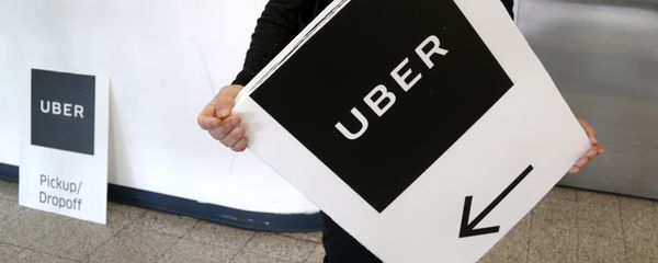An Uber representative put up signs at LaGuardia Airport in New York, Wednesday, March 15, 2017. An Uber representative put up signs at LaGuardia Airport in New York, Wednesday, March 15, 2017. - Sputnik International