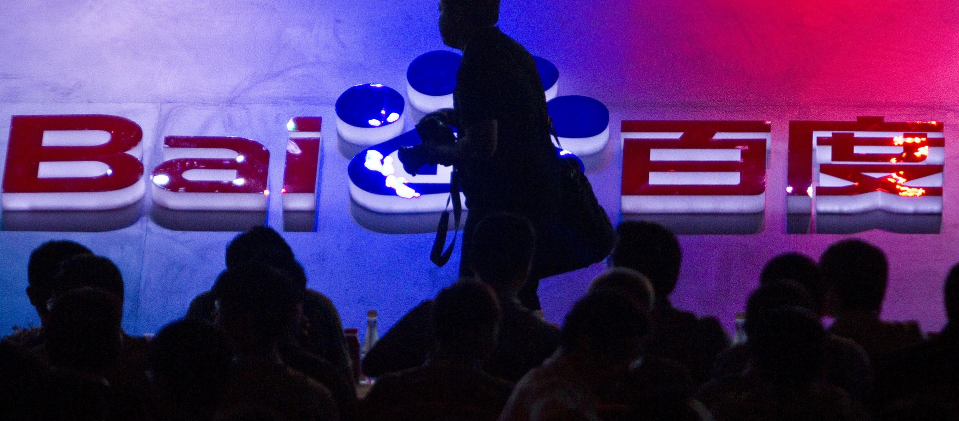 FILE - In this Sept. 2, 2011 file photo, a photographer walks past the logo of Baidu Inc., which operates China's dominant search engine, during a technology innovation conference held by the company at China's National Convention Center in Beijing, China. China issued new regulations on Saturday, June 25, 2016 demanding search engines clearly identify paid search results, months after a terminally-ill cancer patient complained that he was misled by the giant search engine Baidu. FILE - In this Sept. 2, 2011 file photo, a photographer walks past the logo of Baidu Inc., which operates China's dominant search engine, during a technology innovation conference held by the company at China's National Convention Center in Beijing, China. China issued new regulations on Saturday, June 25, 2016 demanding search engines clearly identify paid search results, months after a terminally-ill cancer patient complained that he was misled by the giant search engine Baidu. - Sputnik International, 1920, 15.03.2021