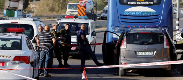 An Israeli policeman inspects the scene of a Palestinian car ramming attack at the Gush Etzion Junction, south of the West Bank city of Bethlehem April 19, 2017 An Israeli policeman inspects the scene of a Palestinian car ramming attack at the Gush Etzion Junction, south of the West Bank city of Bethlehem April 19, 2017 - Sputnik International