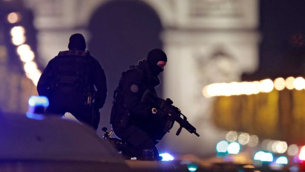 Masked police stand on top of their vehicle on the Champs Elysees Avenue after a policeman was killed and two others were wounded in a shooting incident in Paris, France, April 20, 2017. Masked police stand on top of their vehicle on the Champs Elysees Avenue after a policeman was killed and two others were wounded in a shooting incident in Paris, France, April 20, 2017. - Sputnik International