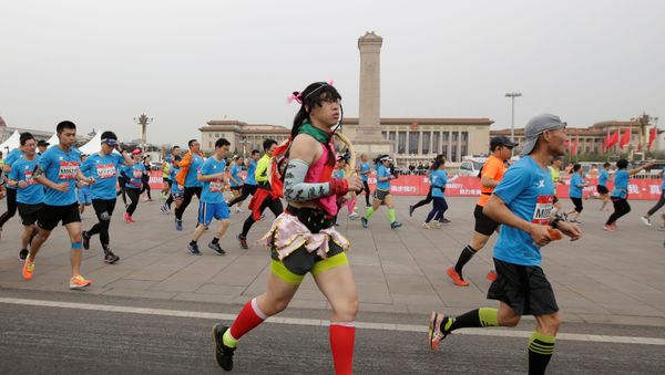 Participants run past Tiananmen Square during the annual Beijing International Running Festival and Beijing Half Marathon, in Beijing China April 16, 2017. - Sputnik International