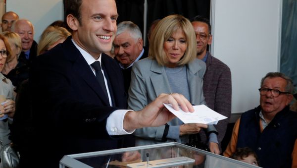 Emmanuel Macron (L), head of the political movement En Marche !, or Onwards !, and candidate for the 2017 French presidential election, casts his ballot in the first round of 2017 French presidential election at a polling station in Le Touquet, northern France, April 23, 2017. At C, his wife Brigitte Trogneux. Emmanuel Macron (L), head of the political movement En Marche !, or Onwards !, and candidate for the 2017 French presidential election, casts his ballot in the first round of 2017 French presidential election at a polling station in Le Touquet, northern France, April 23, 2017. At C, his wife Brigitte Trogneux. - Sputnik International