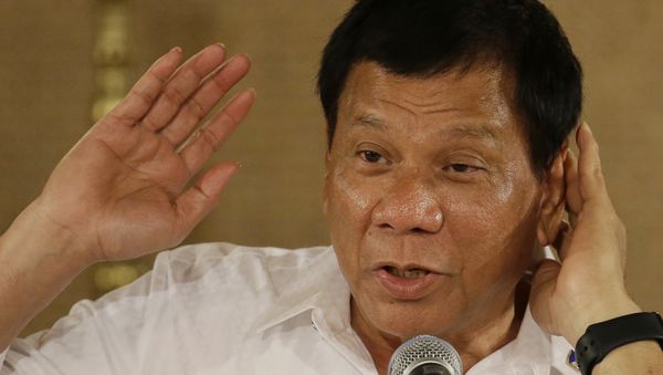 Philippine President Rodrigo Duterte gestures as he answers questions from reporters during a press conference Philippine President Rodrigo Duterte gestures as he answers questions from reporters during a press conference - Sputnik International