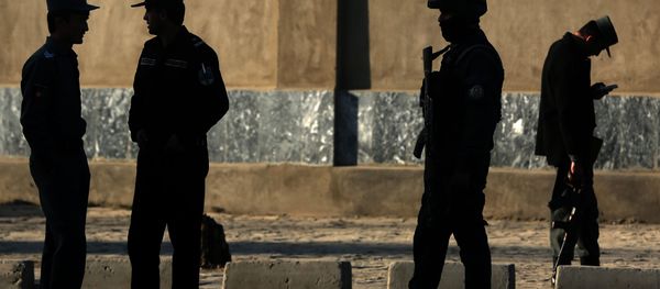 In this Saturday, Feb. 27, 2016 file photo, Afghan National police stand at the site of a suicide attack near the Defense Ministry compound, in Kabul, Afghanistan. - Sputnik International