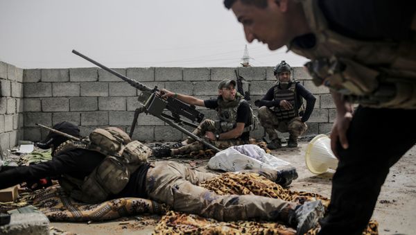 Soldiers with the Iraqi special forces look out on Islamic State group positions from a rooftop in west Mosul as fighting continues, Monday, April 24, 2017 - Sputnik International